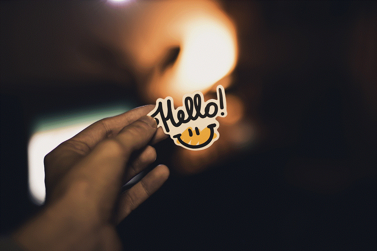 An image of a hand holding a sticker saying Hello!