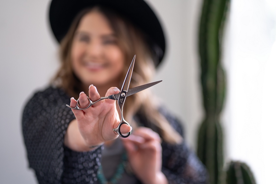 A woman holding a pair of scissors